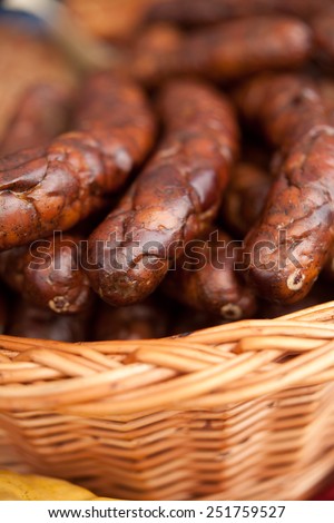 Smoked wild boar sausages in a wooden basket. Eco food, Organic food, fresh meet. Macro perspective, nobody. Agriculture.