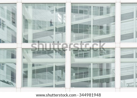 Worker getting lost inside the urban jungle and white glass office bridges, corridors and stories