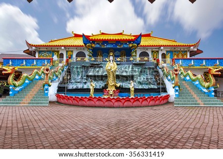 Colorful Chinese and Buddhism temple with its priest and dragons leading to the hostel