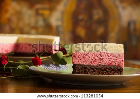 Chocolate mousse cake and strawberries with remaining cake background.