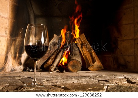 A cup of wine with fire on the background, romantic meal. Love. Write your own message.
