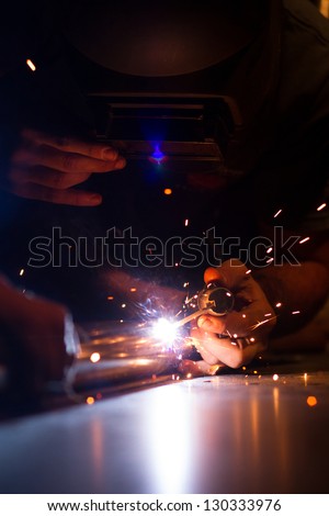 Man Welding with sparks.