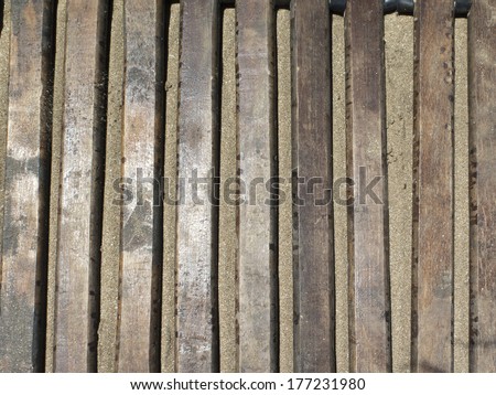 Texture of wooden floor for protection for the feet of the warm sand on beaches.