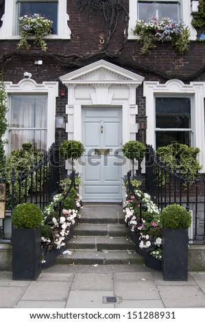 blue door decorated with flowers and plants