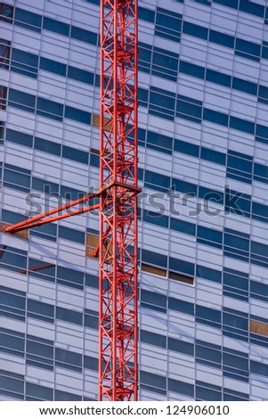 Vertical view of the crane attached to the skyscraper under construction in the Warsaw downtown, Poland