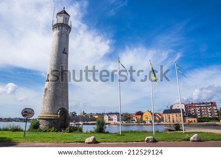 Lighthouse and cityscape of Karlskrona. City is known for rare in Sweden baroque architecture and only remaining naval base and the headquarters of the Swedish Coast Guard.