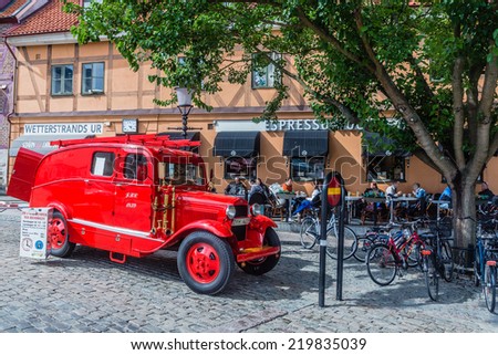 YSTAD, SWEDEN - AUGUST 12, 2014: Old fire dept. car used for city tours in Ystad. City founded in 11th century is a place of action of well-known novels by Henning Mankell with detective Wallander.