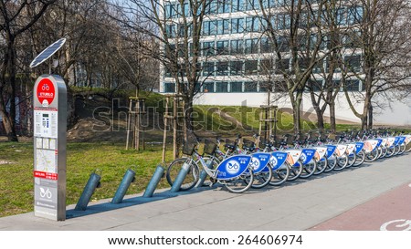 WARSAW, POLAND - MARCH 25, 2015: One of 198 bike stations  in Warsaw by Veturilo company that offers in total 2968 bikes for rental. Traversing the city on a bike is nowadays popular and fashionable.