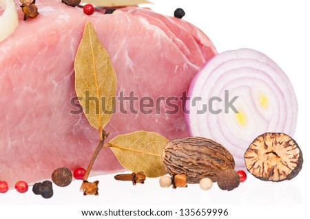 Raw pork with spices and groceries over white background close-up