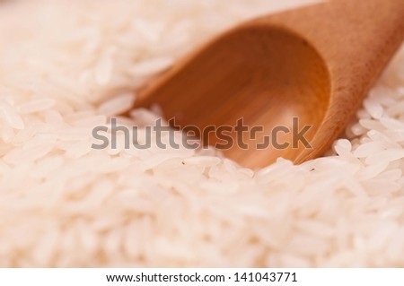 Uncooked basmati rice with bamboo spoon close-up