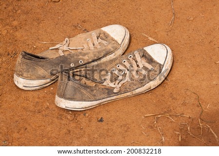 old sneaker on soil floor