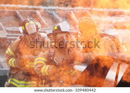 Firemen extinguishing a car fire
