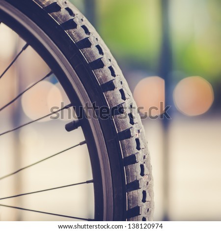 Detail Of A Mountain Bike Tire With Four Lights In The Background (Vintage Style)