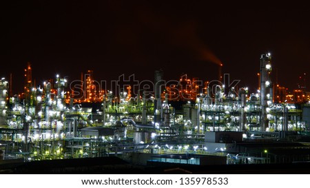 A petrochemical plant, with it\'s stainless steel cylinders, it\'s valves, chimneys, pipes