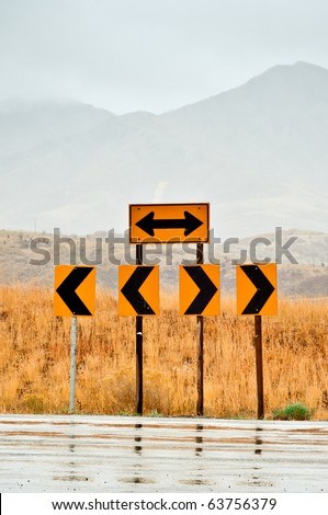 Road signs at the end of the road pointing left and right
