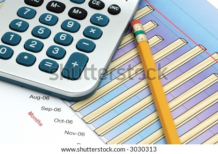 Close-up of Stock Market Volume Bar Chart, Calculator and Pencil