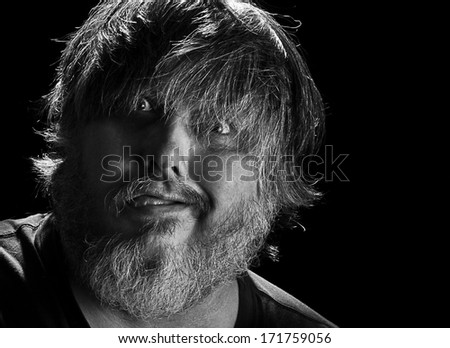 Close up of man with beard making silly face