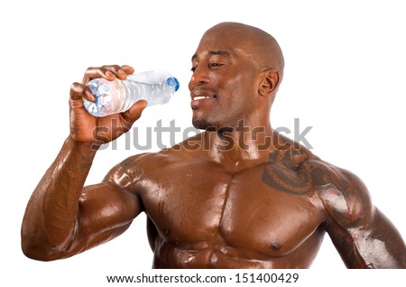 Black bodybuilder drinking water after a hard workout. Strong man with perfect abs, shoulders,biceps, triceps and chest. Isolated on white background