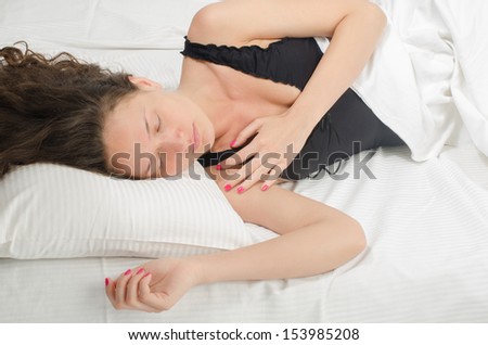 Woman sleeping. Beautiful girl in lingerie falling asleep on a soft pillow