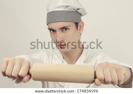 Young chef in the kitchen angry and ready prepare the best food