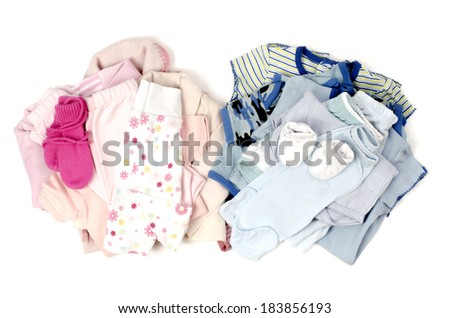 Close up with a blue stack of clean baby clothes for a boy and a pink clean babby clothes for a girl isolated on white