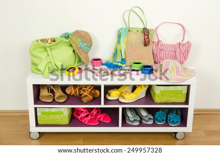 Lots of colorful summer accessories on a shelf. Bags, jewelry, shoes and sandals nicely arranged on a shelf