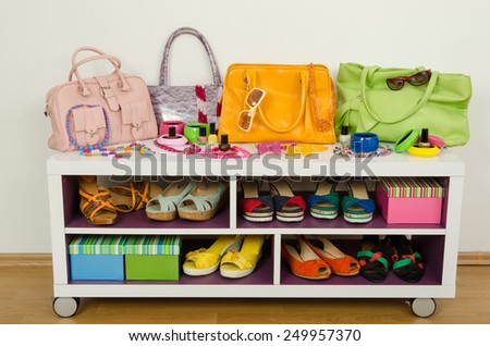 Lots of colorful summer accessories on a shelf. Bags, jewelry, shoes and sandals nicely arranged on a shelf