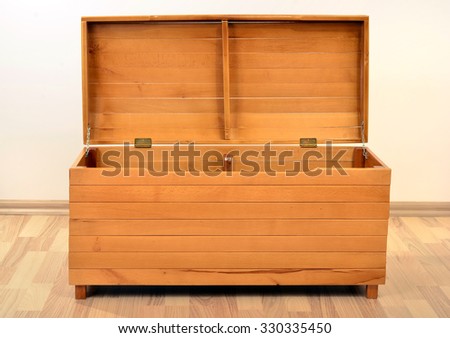 Empty chest with the lid opened. Big brown wood trunk on the floor.