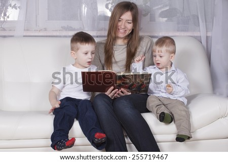 mother reading a book to children