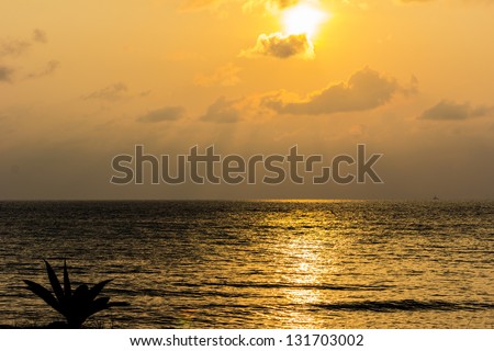 sunrise gold sky clouds sunbeams at sea Thailand.