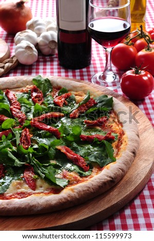 Pizza of arugula and sundried tomatoes