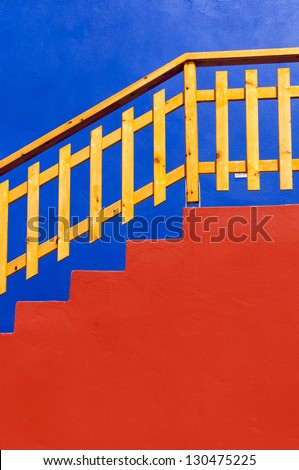 Red stairs with a wooden fence