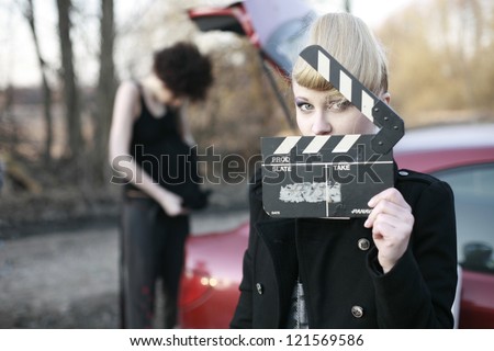 the girl in the film production with clapperboard