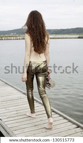 Girl leaving the pier, from behind with long beautiful hair