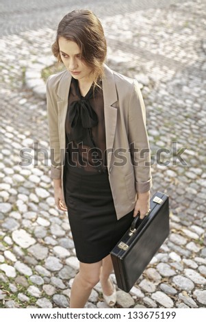 young beautiful business woman with business suitcase