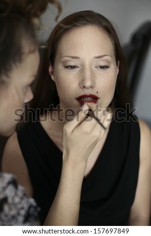 image of production make up, beautiful blonde girl is having a production of her make up, film production, actress
