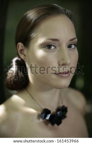 image of young seductive woman with an interesting necklace, seductive, enticing view