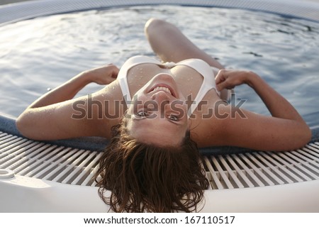 young women in the relaxation pool, Young woman relaxing at the edge of a hot pool at spa center