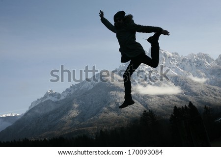 silhouette of a man in the air, man jumping on a sunset background,