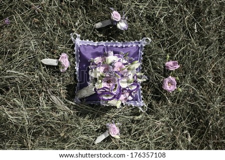 purple wedding bouquet in a vase and pad on hay, bouquet  on the straw ,Bridal wedding bouquet of flowers. Wedding bouquet of yellow and white roses lying on a grass