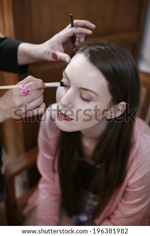 image of production make up, beautiful blonde girl is having a production of her make up, film production, actress