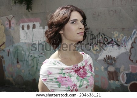 portrait of happy business woman, young and beautiful woman by the graffiti wall , smiling girl happy business woman, young and beautiful woman in the city park, smiling girl