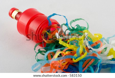 A party popper which has been popped leaving the streamers on display.