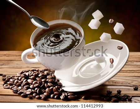 Falling cup coffee, spoon and sugar cubes are falling down also.