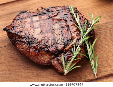 Beef Steak On A Wooden Table.