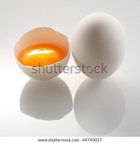 white egg and a half eggs on a white background.