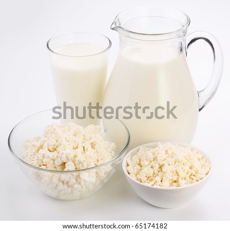 Jar and glass of milk and two bowl with cottage cheese. Isolated on a white.