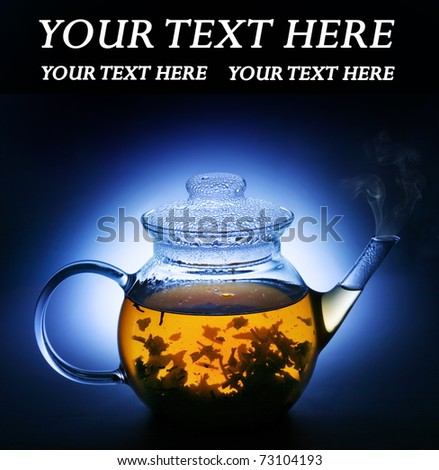 Transparent teapot of hot tea on a dark background.