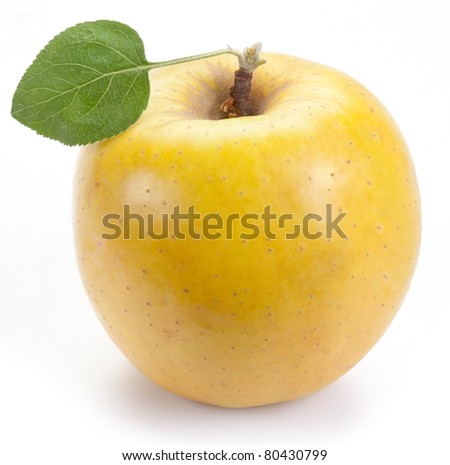 Ripe yellow apple with one leaf. Isolated on  white background.