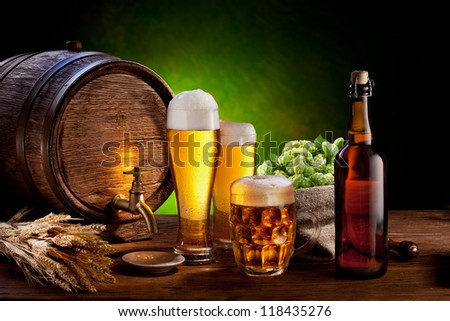 Beer Barrel With Beer Glasses On A Wooden Table. The Dark Green Background.